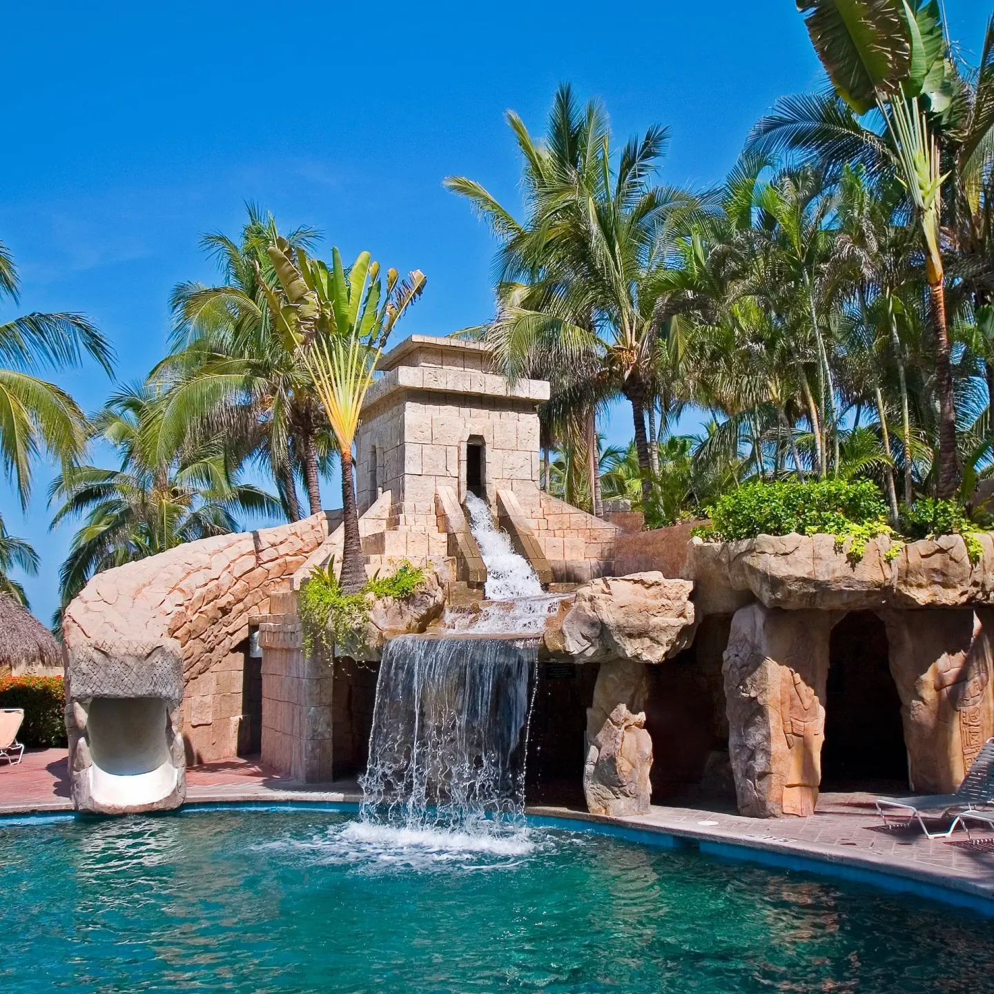 Temple-style pool waterfall and slide area at Paradise Village Beach Resort and Spa.