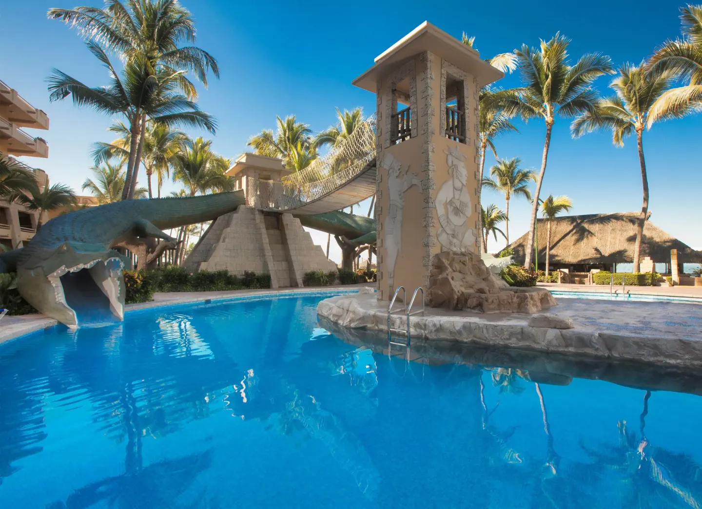 Pool with a tower bridge and crocodile slide at Paradise Village Beach Resort and Spa.