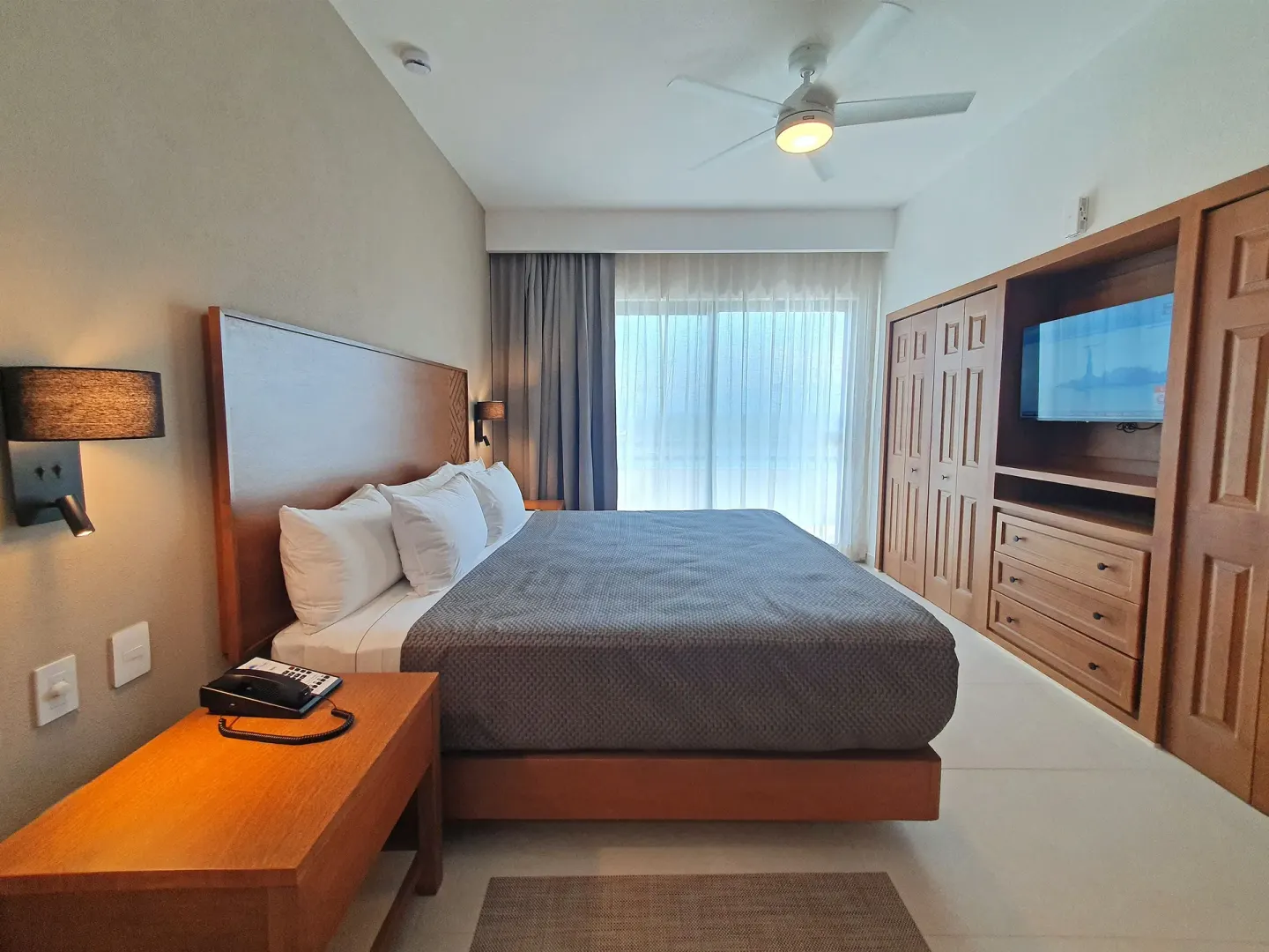 Bedroom with king bed in the 2 Bedroom Superior Suite Coba at Paradise Village Beach Resort and Spa.