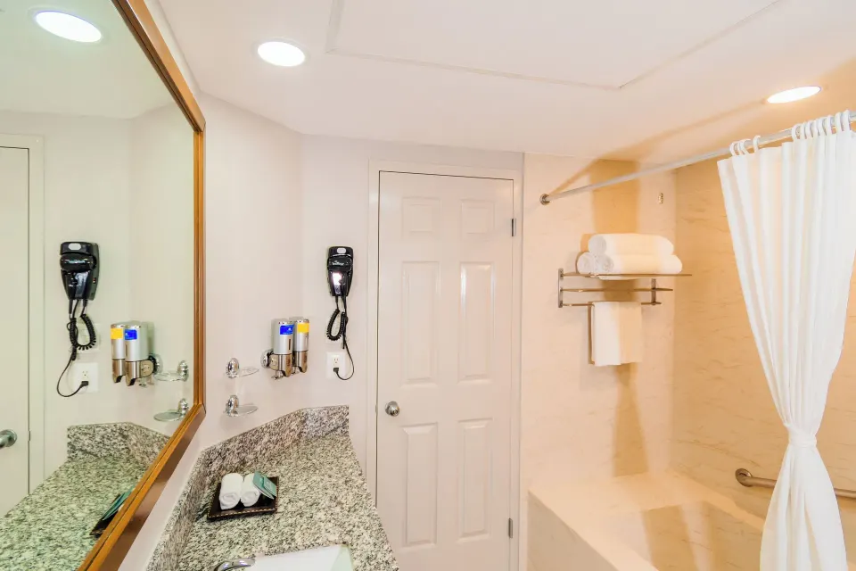 Superior Studio Suite bathroom with vanity and shower at Paradise Village Beach Resort and Spa.