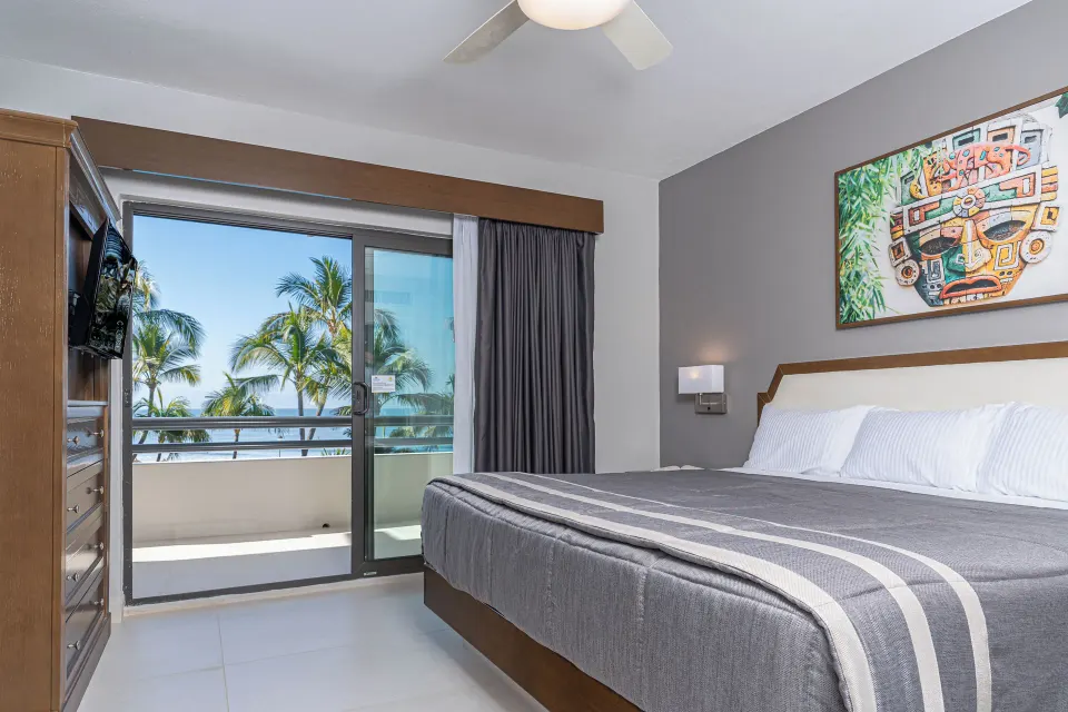 Superior Suite 1 Bedroom king bed and balcony at Paradise Village Beach Resort and Spa.