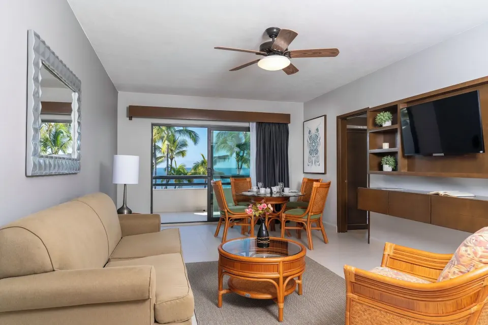 Superior Suite 1 Bedroom lounge with dining table and balcony at Paradise Village Beach Resort and Spa.