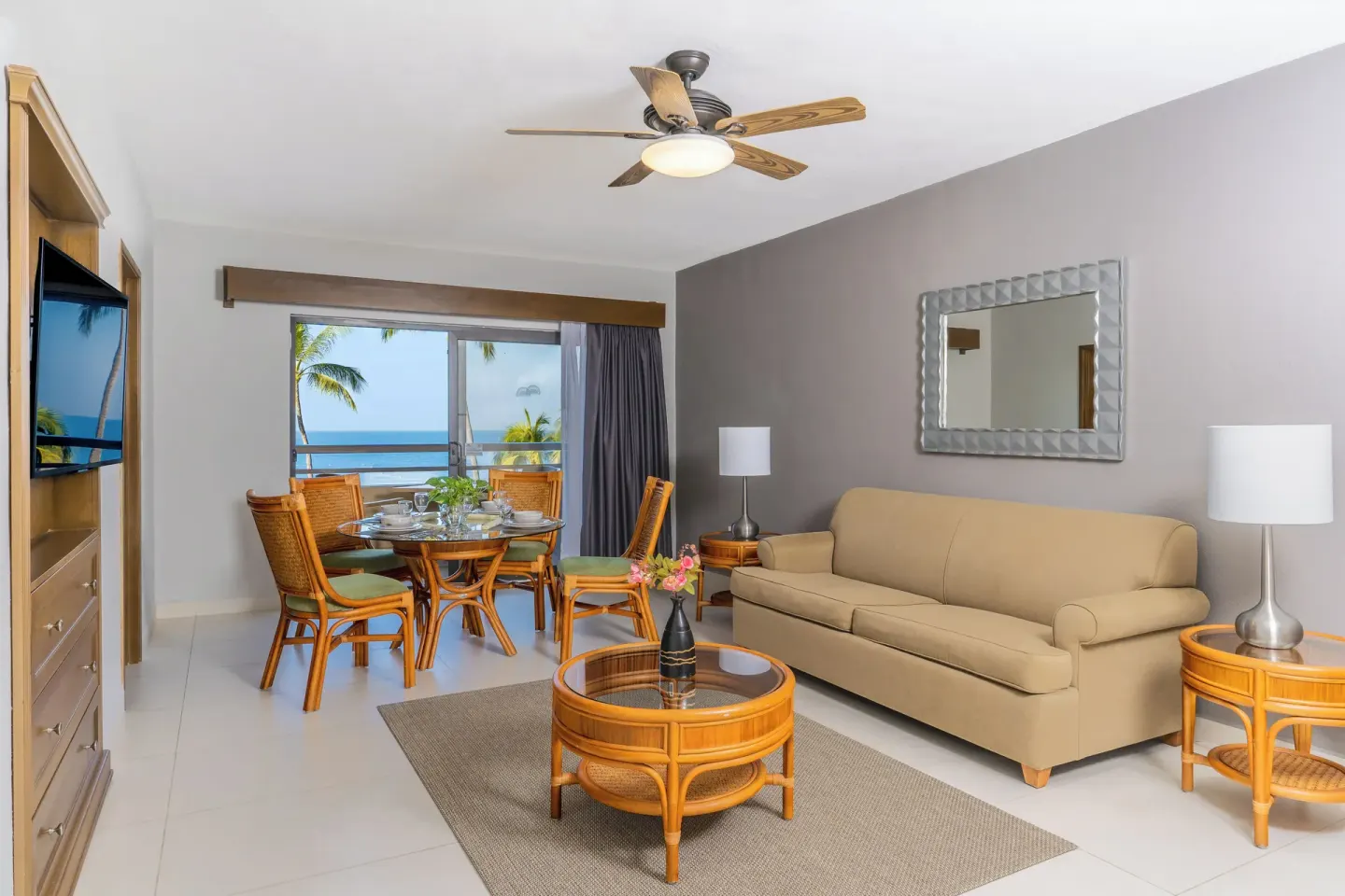 Superior Suite 1 Bedroom sitting area with ocean-view windows at Paradise Village Beach Resort and Spa.