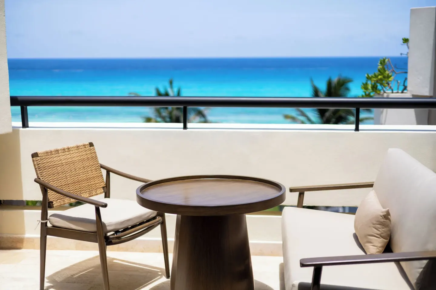 Balcony lounge seating at Paradisus Cancún with a table, chair, sofa, and ocean view.