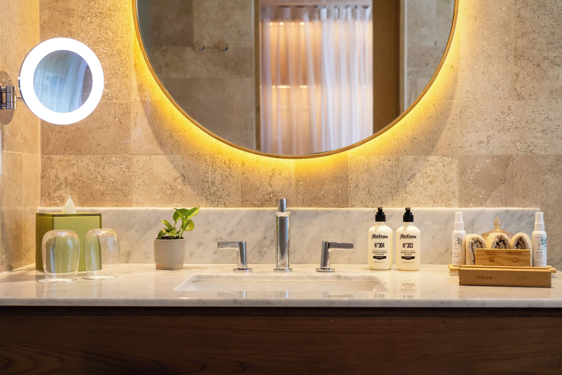 Bathroom vanity with lit mirrors and bath amenities at Paradisus Cancún.