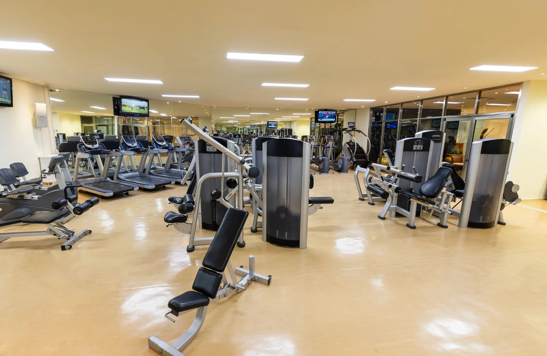 Fitness center with treadmills, weight machines, and benches at Paradisus Cancún.