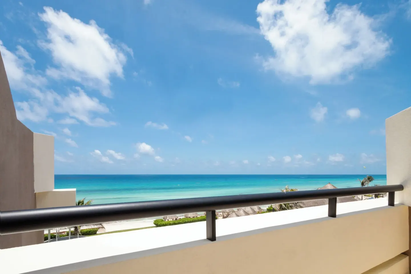 Ocean view from a resort balcony at Paradisus Cancún with turquoise water and blue sky.