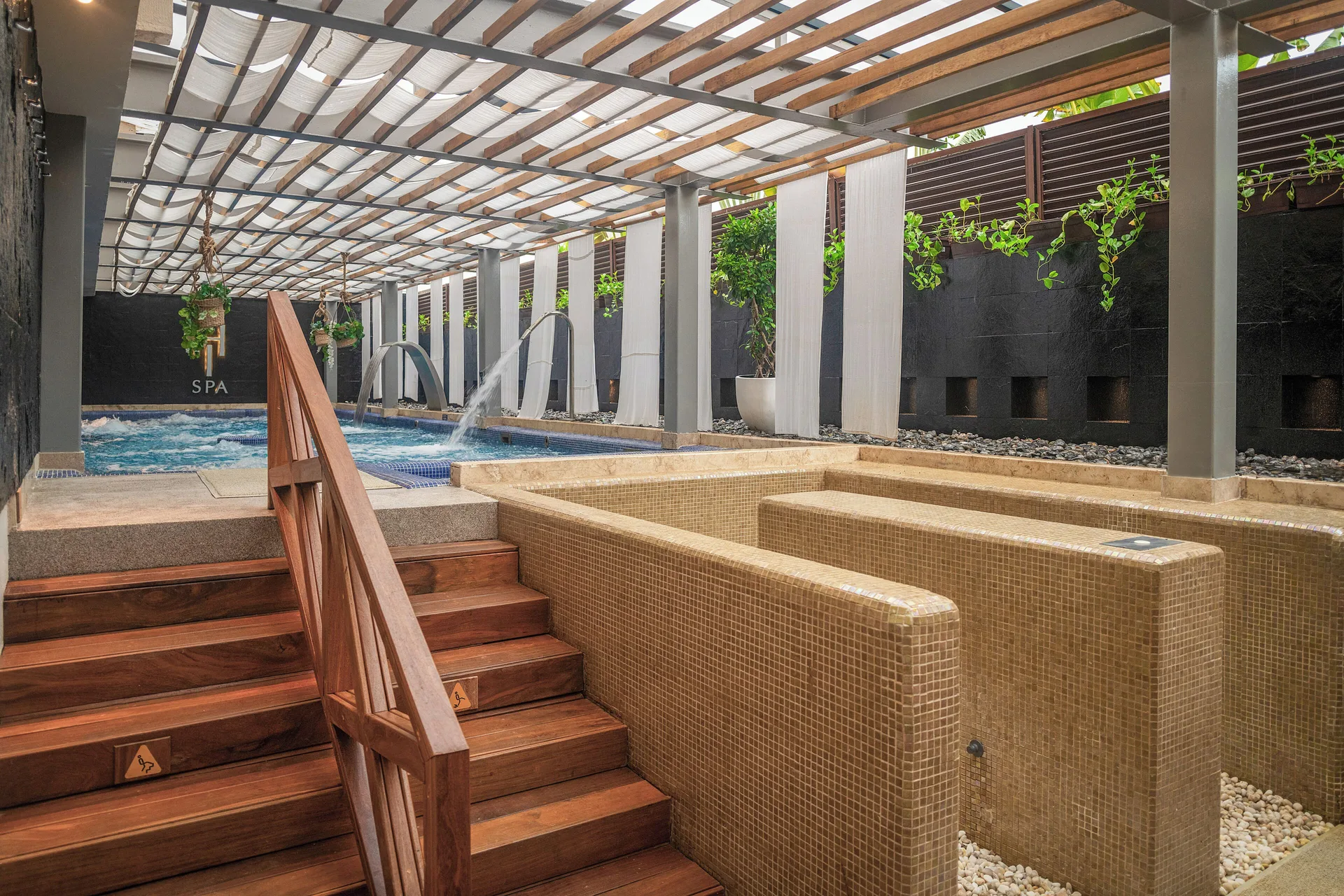 Spa hydrotherapy pools and tiled tubs under a pergola at Paradisus Cancún.