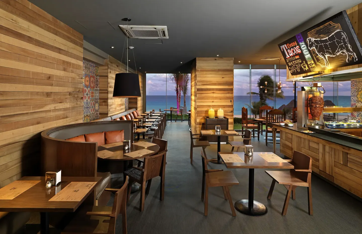 Taqueria-style dining room with ocean views and taco signage at Paradisus Cancún.