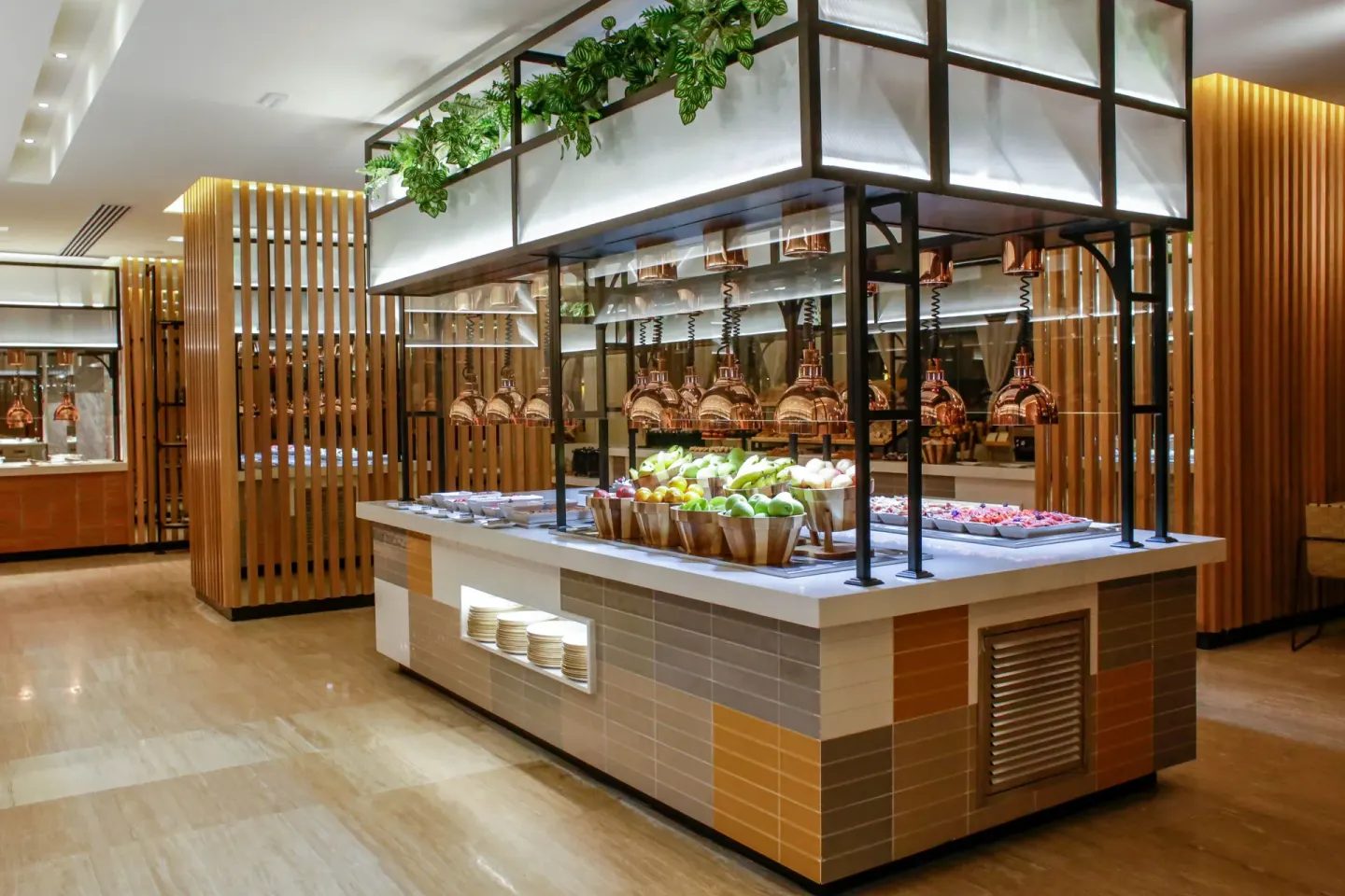 Buffet station with fruit and copper lamps at Paradisus Cancún.
