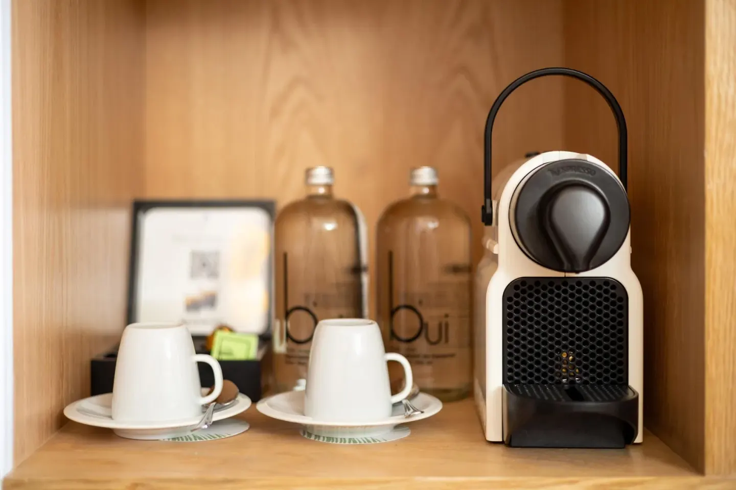 In-room coffee machine, cups, and water bottles in a Family Concierge suite at Paradisus Cancún.