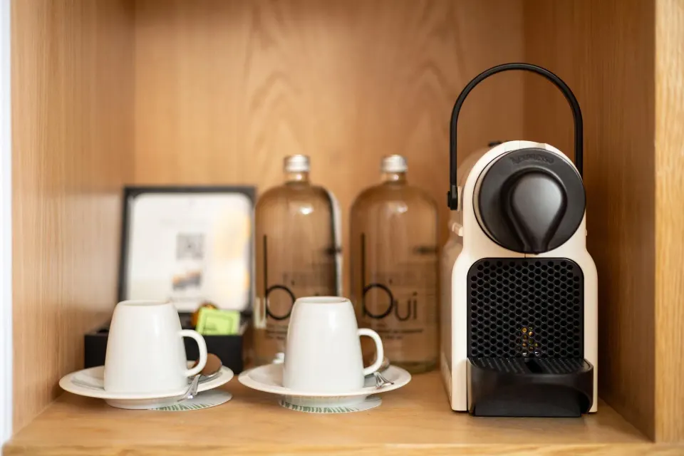 In-room coffee machine, cups, and water bottles in a Family Concierge suite at Paradisus Cancún.
