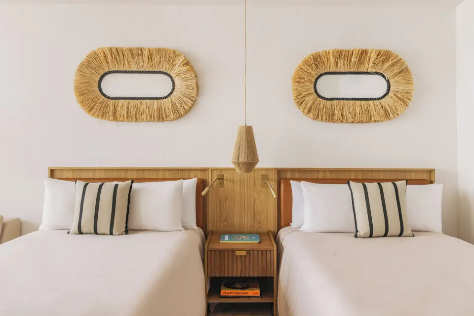 Family Concierge Junior Suite Sunset View with two beds and woven wall decor at Paradisus Cancún.