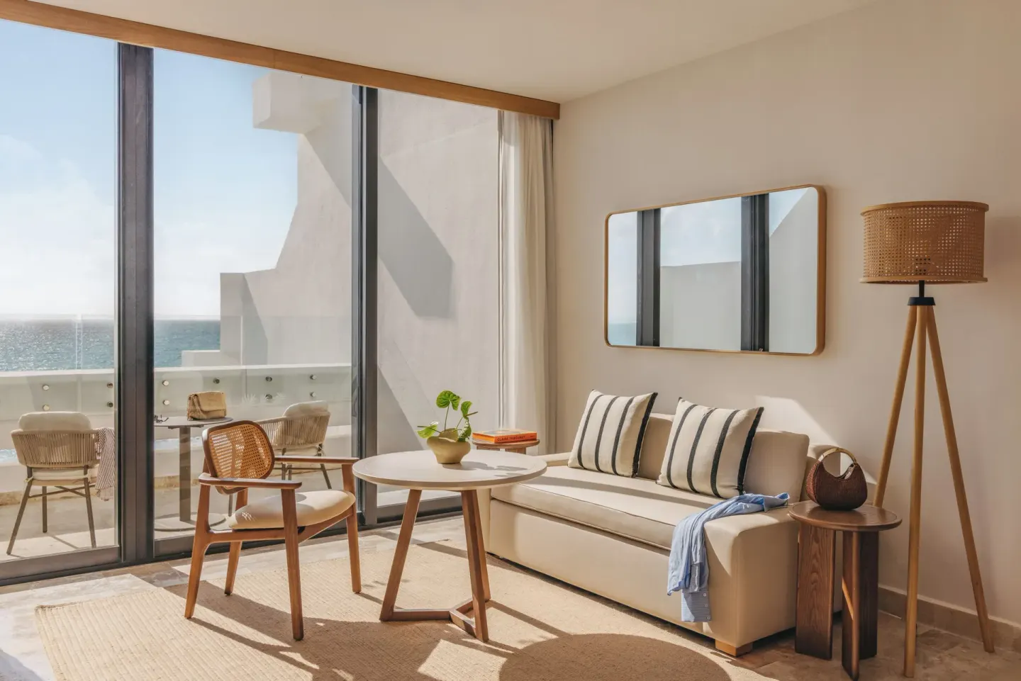 Sitting area and balcony in a Family Concierge Suite Ocean View at Paradisus Cancún.