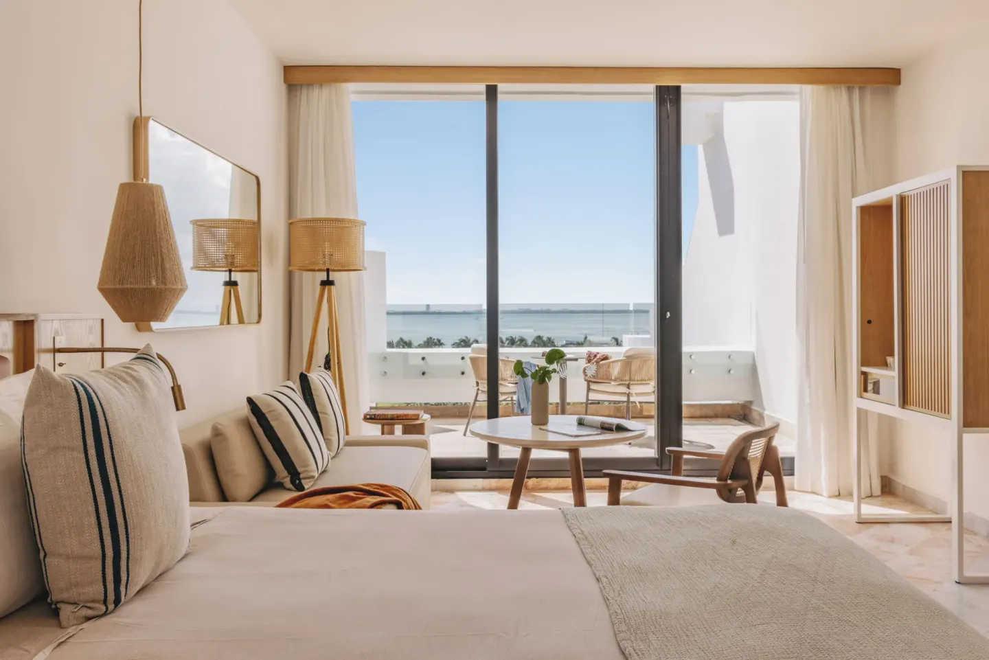 Family Concierge two-bedroom suite with bed, seating, balcony and water view at Paradisus Cancún.