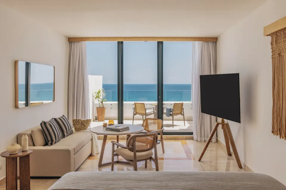 Governor Suite bedroom seating area with balcony and ocean view at Paradisus Cancún.