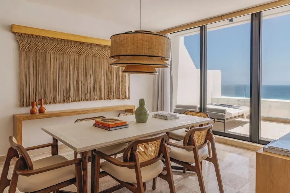 Governor Suite dining table beside balcony doors at Paradisus Cancún.