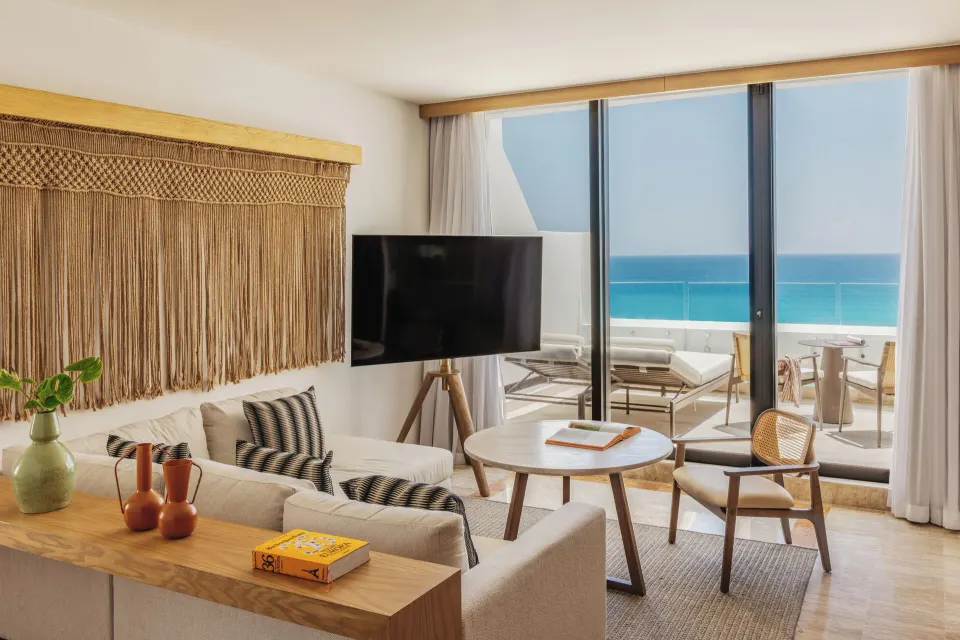Governor Suite living area with balcony and ocean view at Paradisus Cancún.