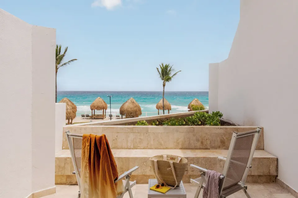 Junior Suite Ocean View terrace with chairs facing the beach at Paradisus Cancún.