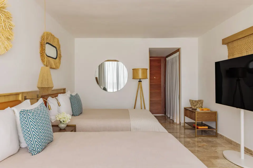 Junior Suite Sunset View double beds and TV at Paradisus Cancún.