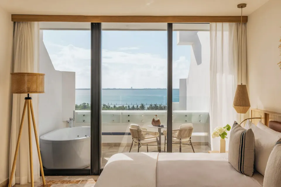 Premium Suite Sunset View king bed and balcony with ocean view at Paradisus Cancún.