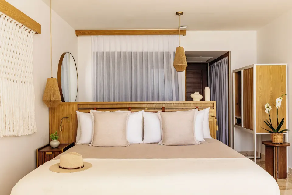 The Reserve Adults Only Junior Suite ocean view bedroom with king bed at Paradisus Cancún.