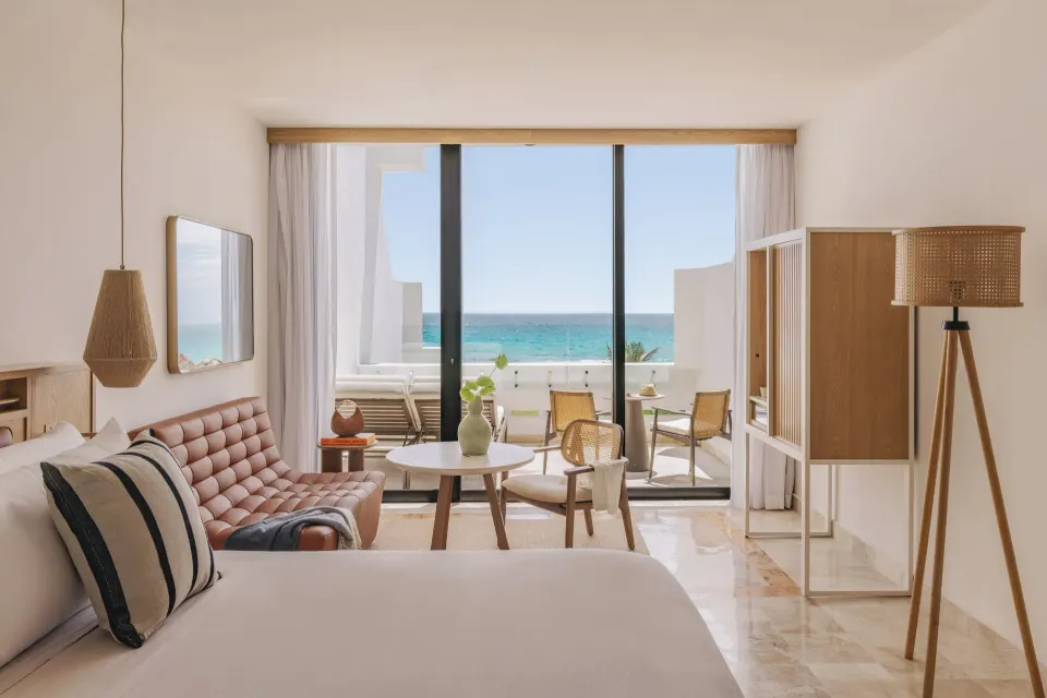 The Reserve Adults Only ocean-view suite with bed, sofa, balcony and sea view at Paradisus Cancún.