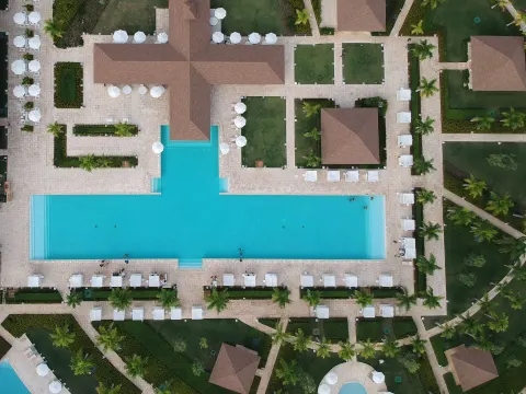 Aerial view of a large rectangular pool and cabanas at Paradisus Grand Cana.