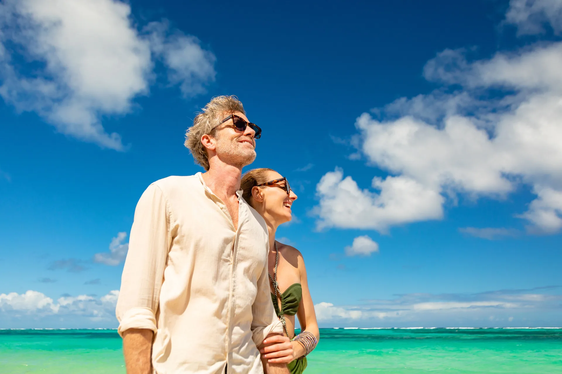 Couple standing by turquoise water at Paradisus Grand Cana.