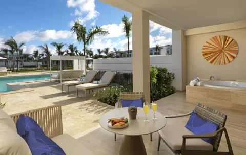 Ground-floor terrace with seating, whirlpool tub, and pool access at Paradisus Grand Cana.