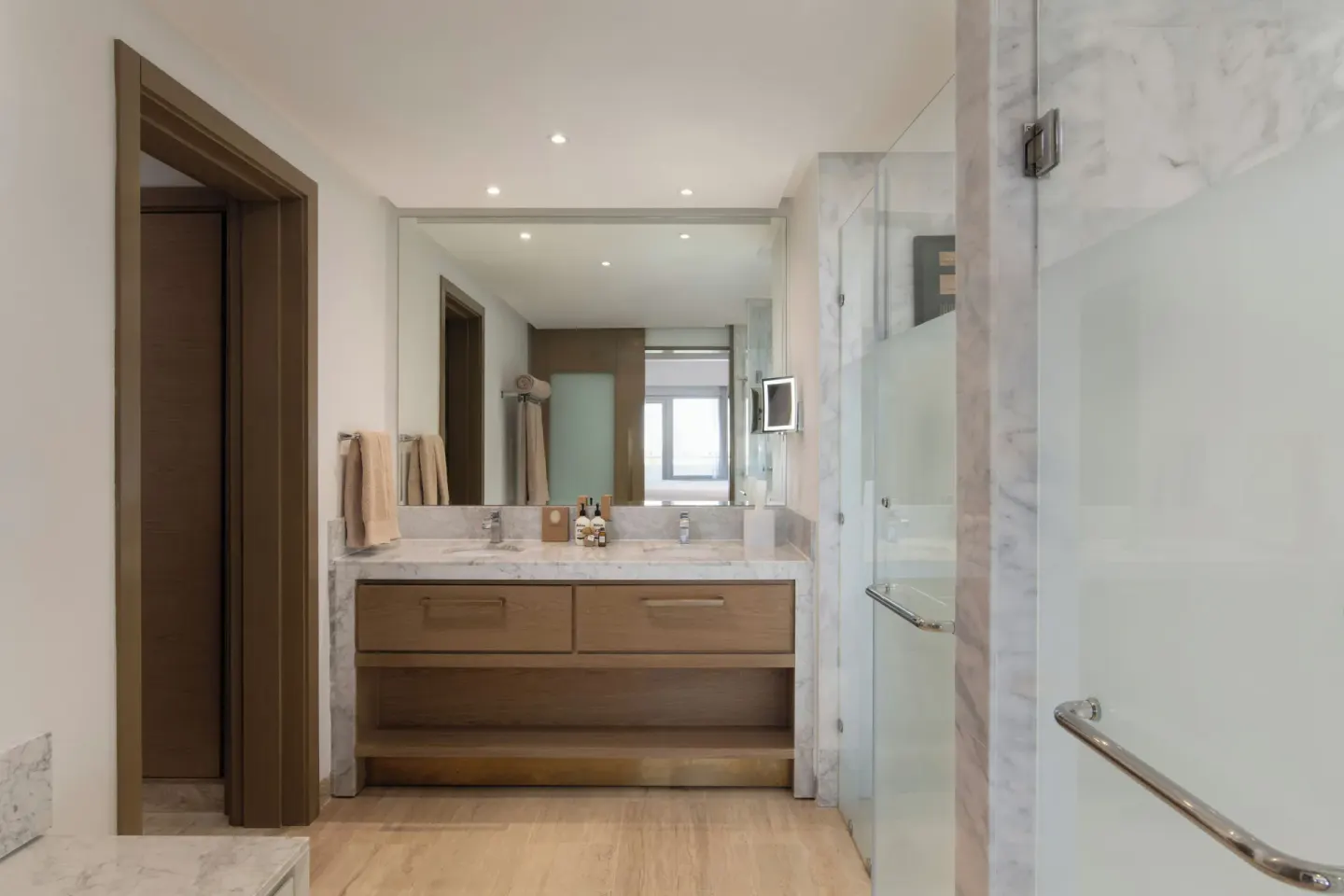 Guest room bathroom with double vanity and glass shower at Paradisus Grand Cana.