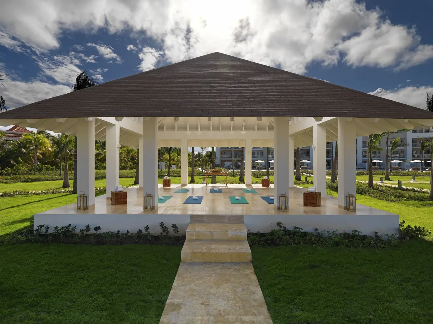 An open-air yoga pavilion with mats set on the lawn at Paradisus Grand Cana.