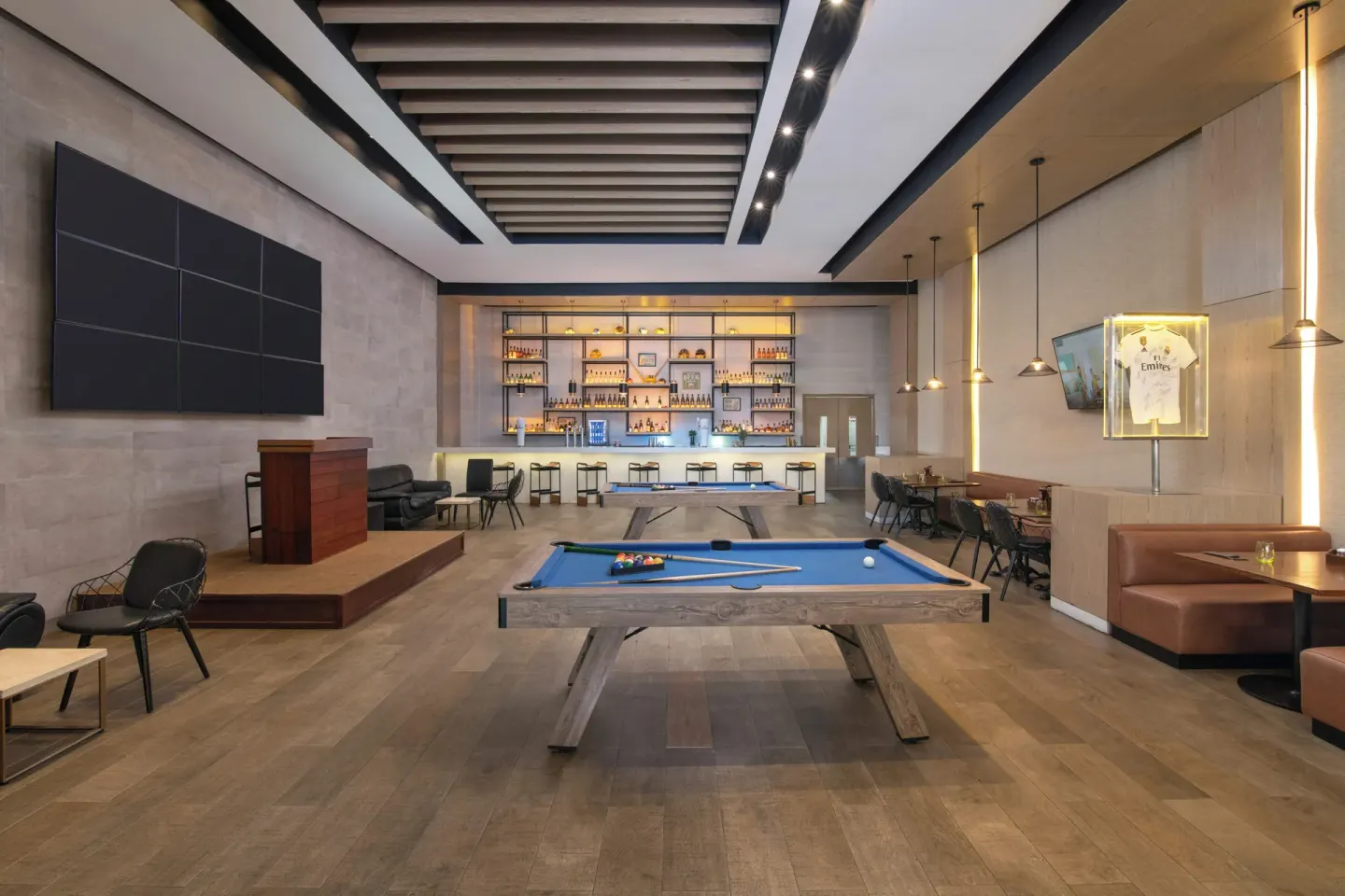 Kicks sports bar with pool tables, screen wall, and back bar at Paradisus Grand Cana.