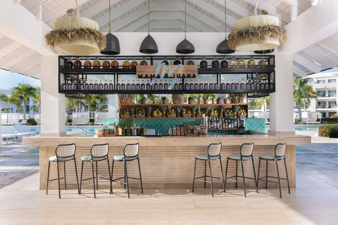 Mama & Juana pool bar with stools and bottles at Paradisus Grand Cana.