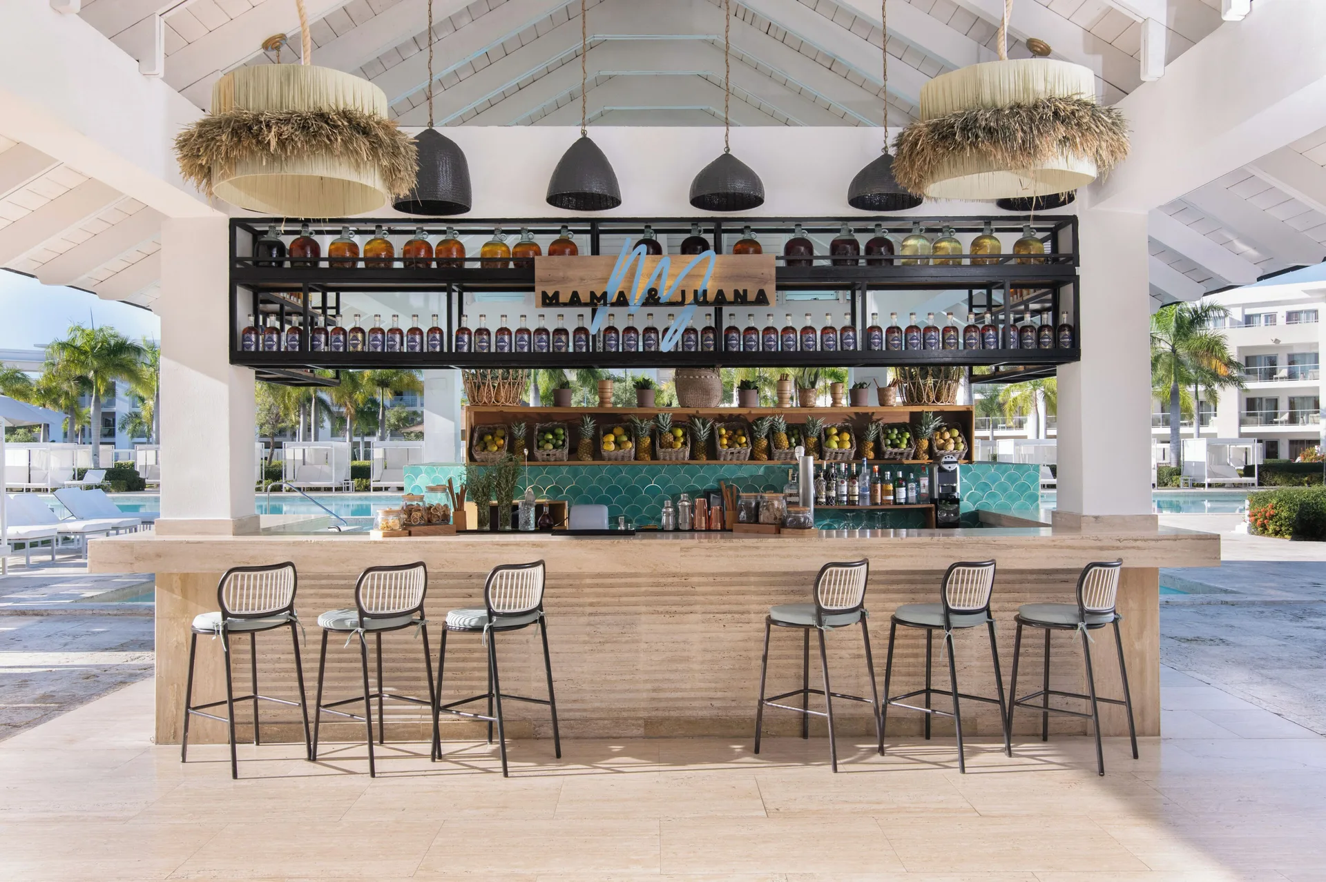 Mama & Juana pool bar with stools and bottles at Paradisus Grand Cana.