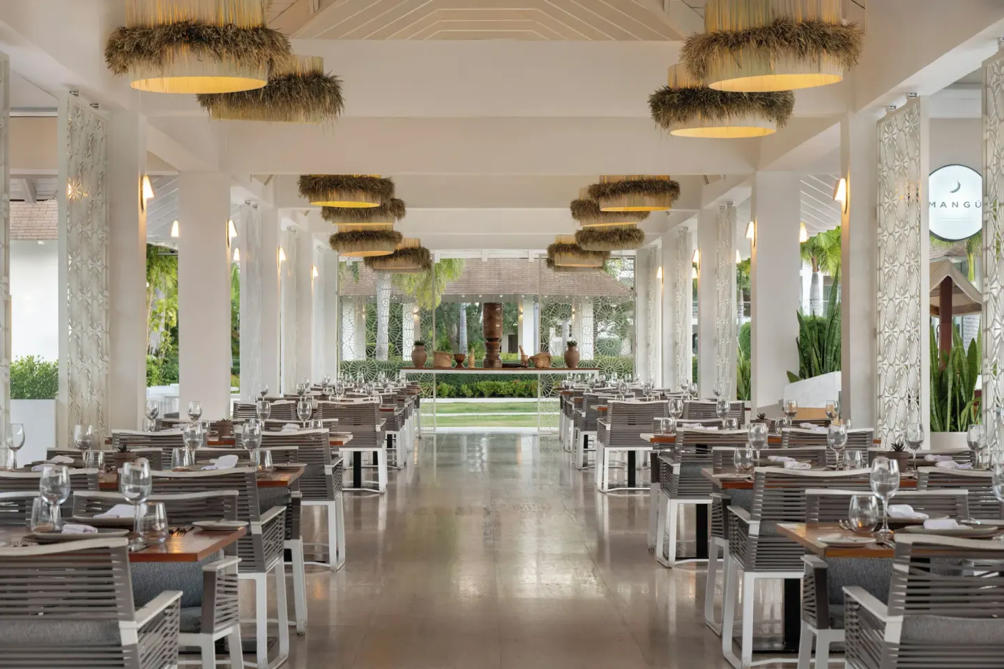 Mangú open-air dining room with set tables and garden views at Paradisus Grand Cana.