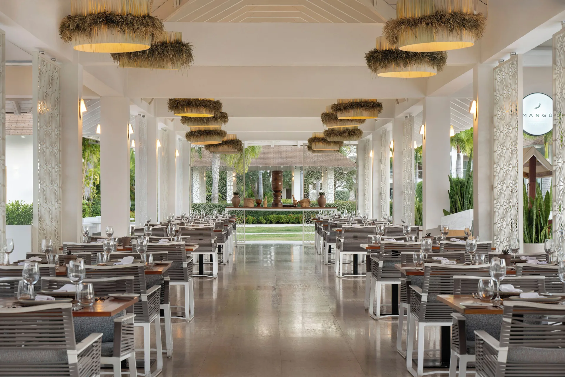 Mangú open-air dining room with set tables and garden views at Paradisus Grand Cana.