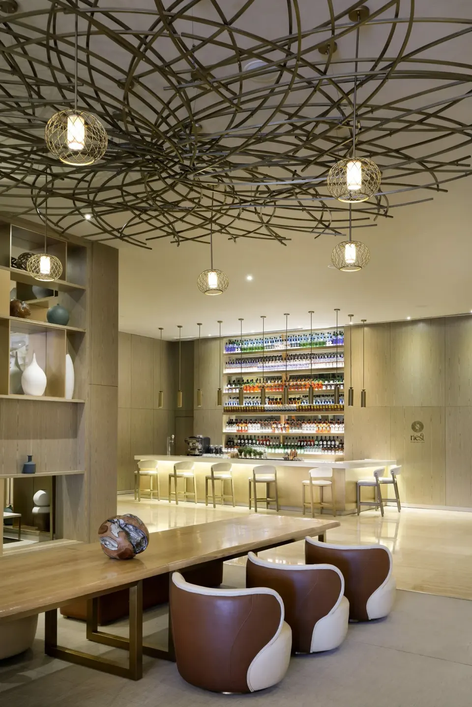 Nest bar with illuminated bottle shelves and lounge seating at Paradisus Grand Cana.