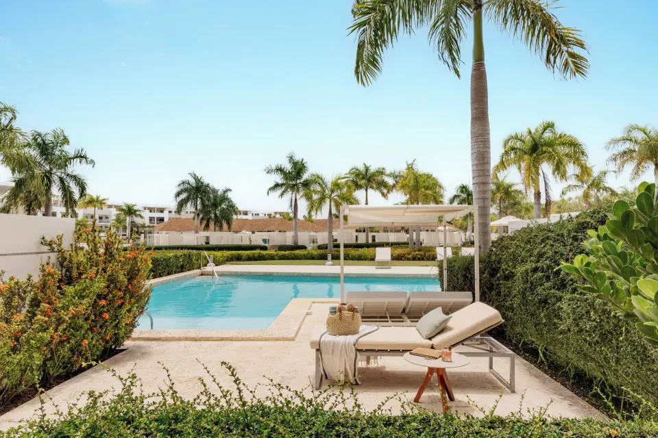 Swim-up suite patio with loungers and pool at Paradisus Grand Cana.