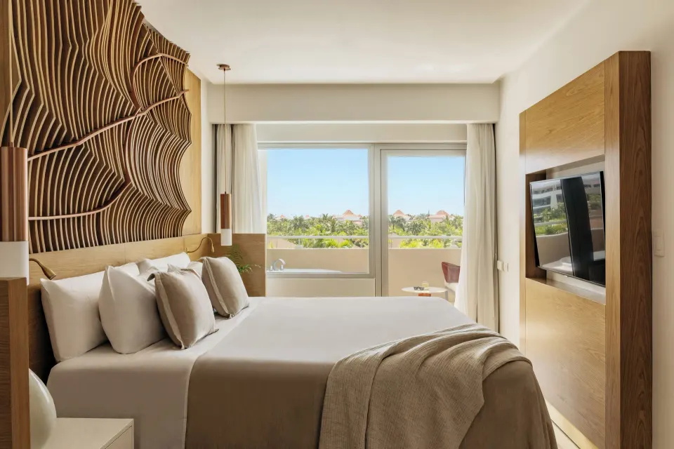 Family Concierge Master Suite king bed with balcony view at Paradisus Grand Cana.