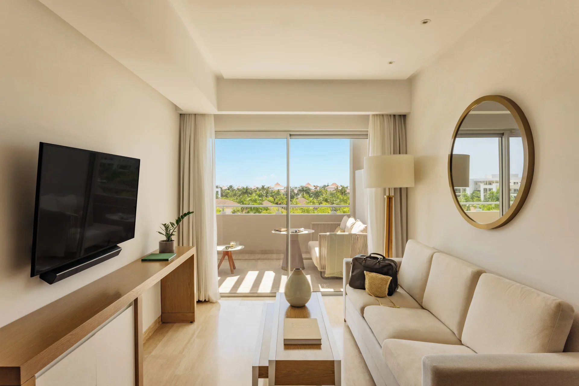Living room with sofa and balcony in the Family Concierge Master Suite at Paradisus Grand Cana.