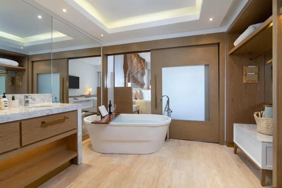 Spacious bathroom with tub, vanity, and closet area at Paradisus Grand Cana.