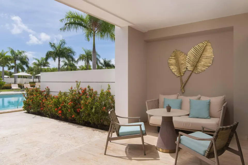 Private patio seating beside the swim-up pool at Paradisus Grand Cana.
