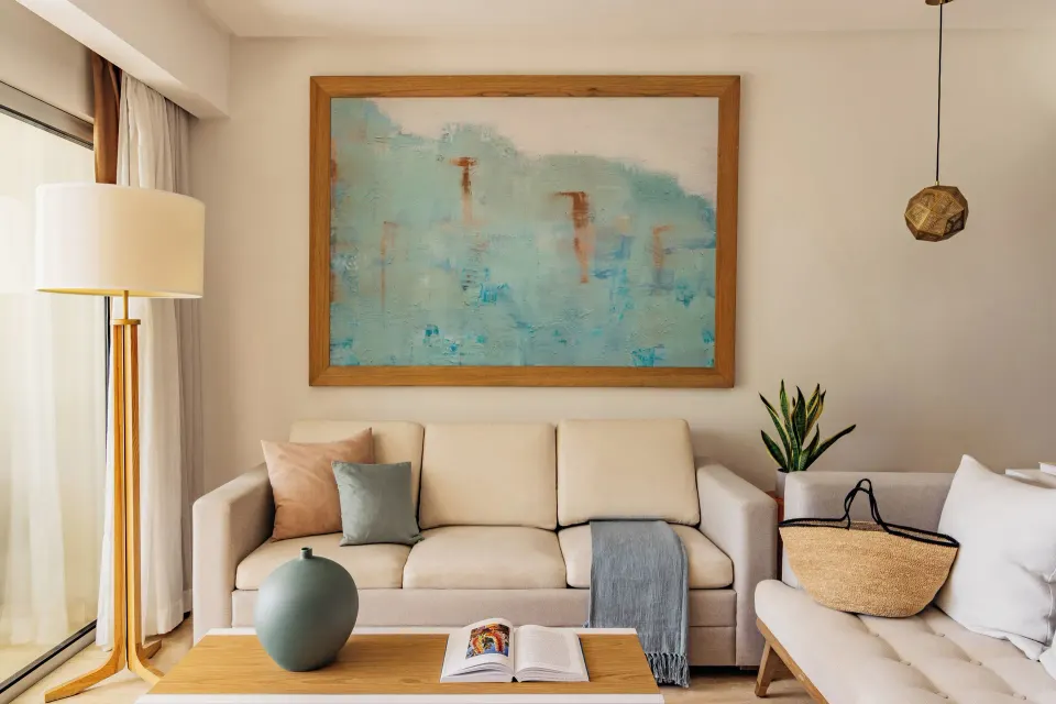 One Bedroom Master Suite living area with sofa, artwork, and coffee table at Paradisus Grand Cana.