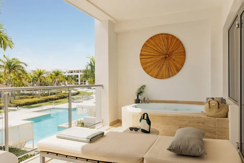 One Bedroom Pool View Suite terrace with daybed and whirlpool at Paradisus Grand Cana.