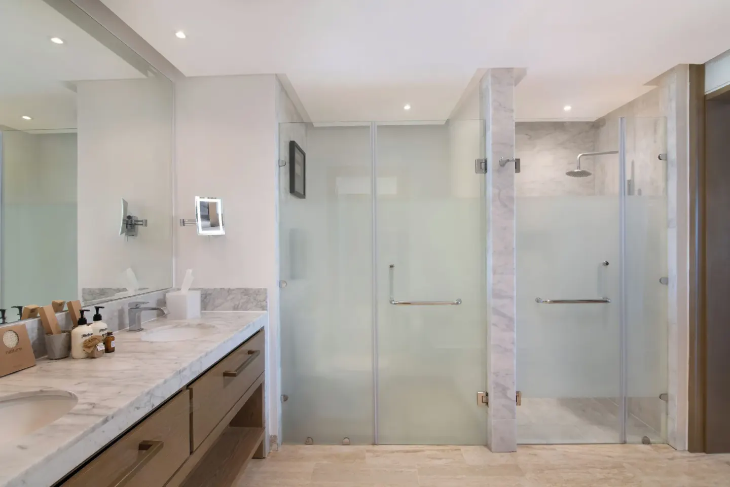 Swim-up suite bathroom with double vanity and glass showers at Paradisus Grand Cana.