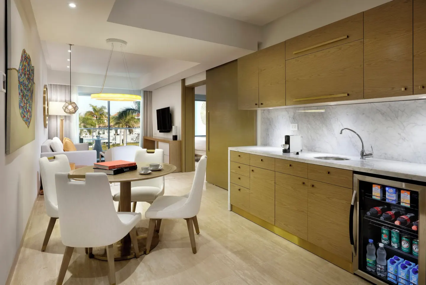 Swim-up suite dining nook and kitchenette at Paradisus Grand Cana with pool-view windows.