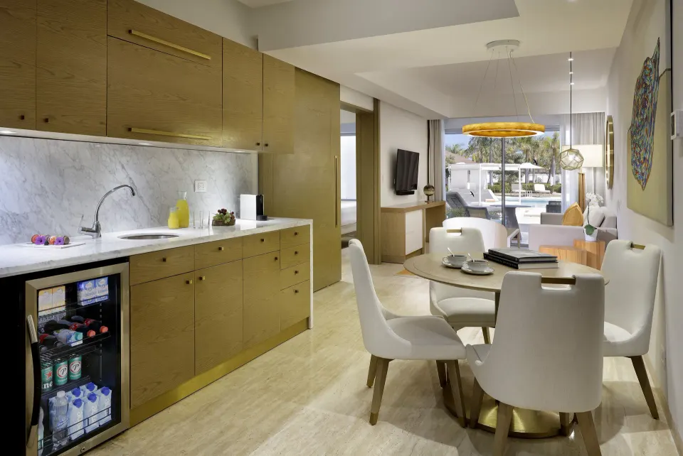 Swim-up suite living and dining area with kitchenette at Paradisus Grand Cana.