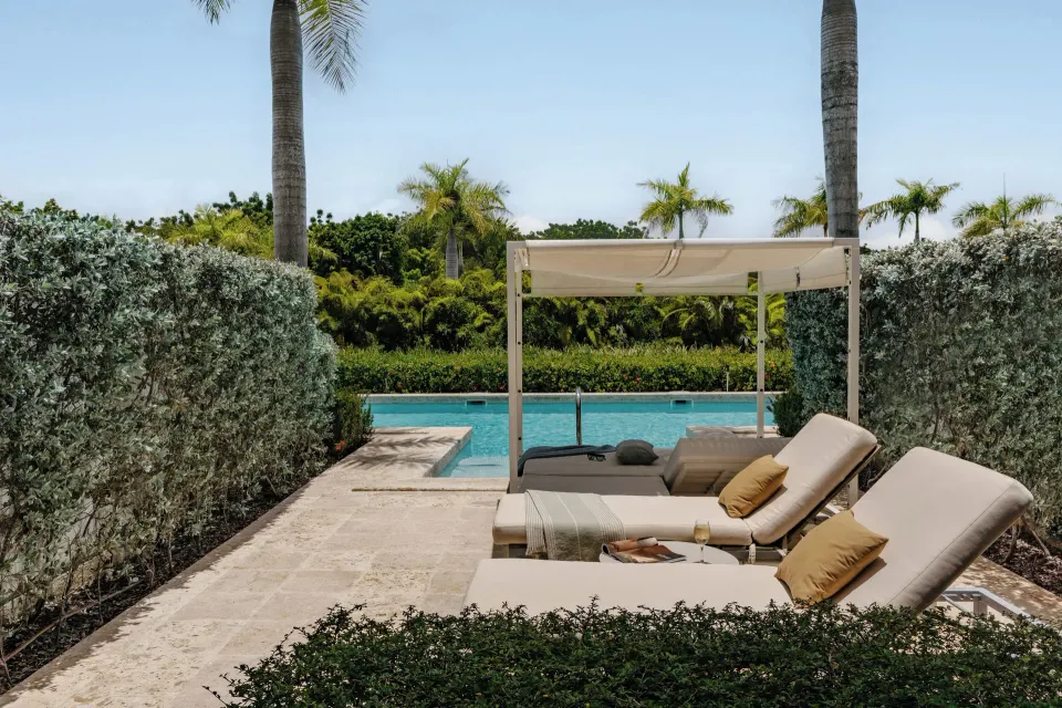 The Reserve One Bedroom Swim Up Suite terrace with loungers and pool at Paradisus Grand Cana.