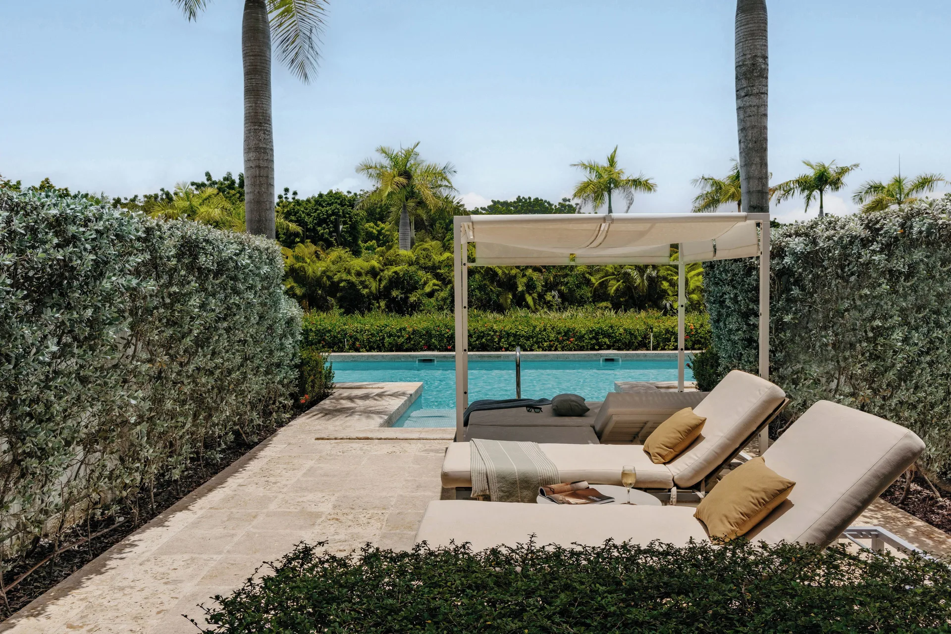 The Reserve One Bedroom Swim Up Suite terrace with loungers and pool at Paradisus Grand Cana.